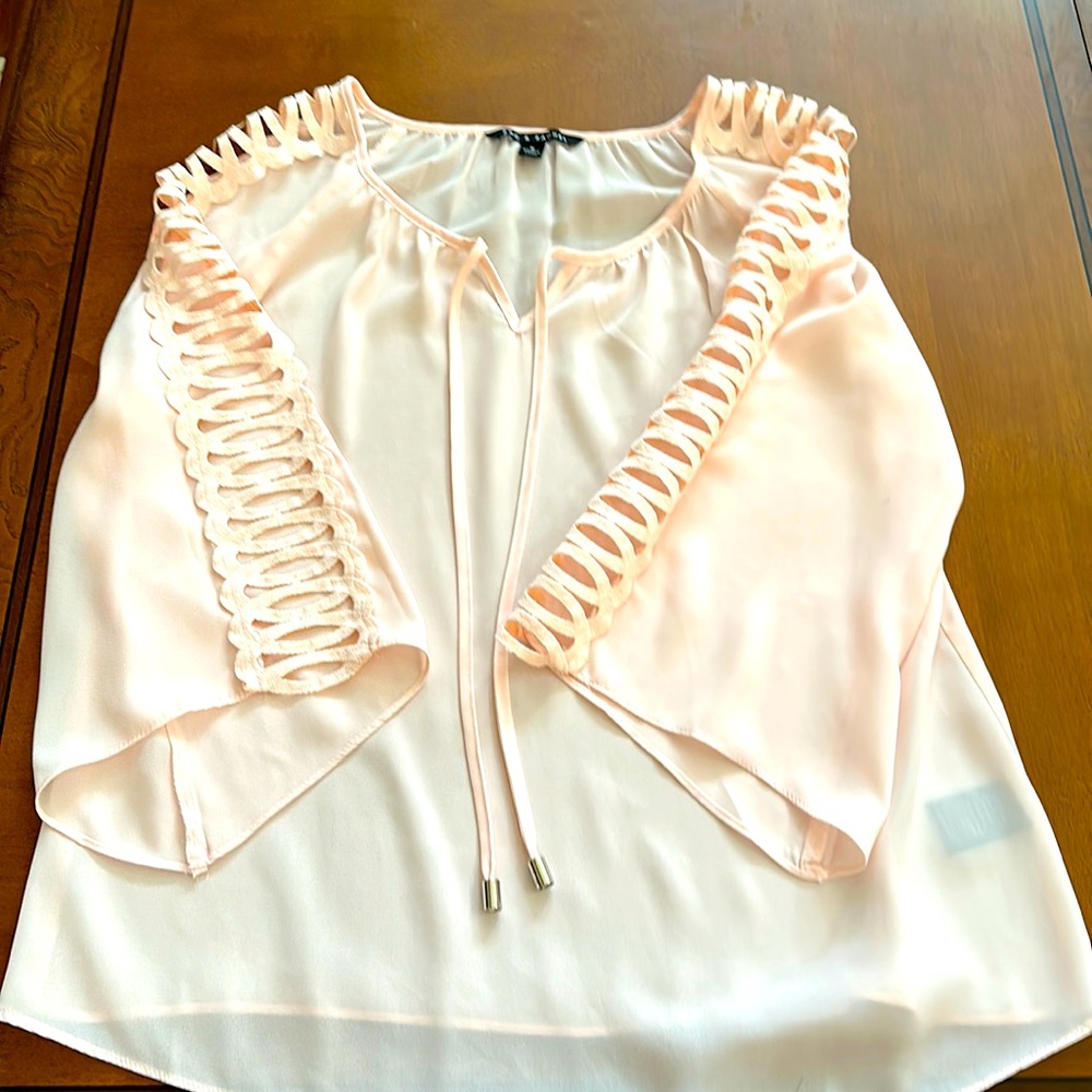 Woman’s Zac & Rachel M long bell sleeve blouse in light peach color. Tie front